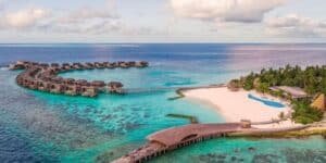 Design meets nature at The St. Regis Maldives Vommuli Resort. This oasis boasts contemporary architectural designs that blend seamlessly into its lush, natural setting. Villas are dotted around the turquoise waters, giving an uninterrupted view of the endless horizon. Whether you’re indulging in the outdoor infinity pool, exploring marine life, or dining in a top-tier restaurant, you’re sure to feel like royalty here.